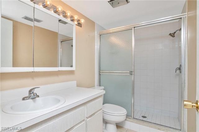 bathroom featuring vanity, toilet, tile patterned floors, and a shower with door