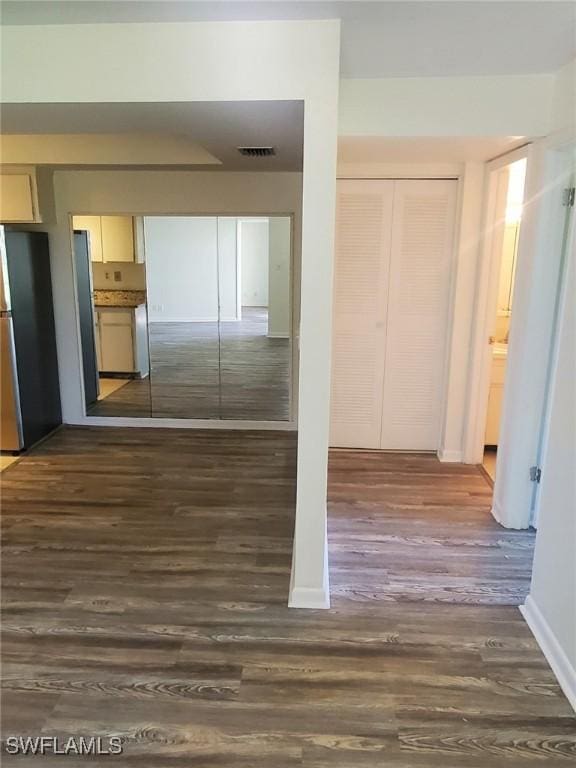 hallway featuring dark hardwood / wood-style flooring