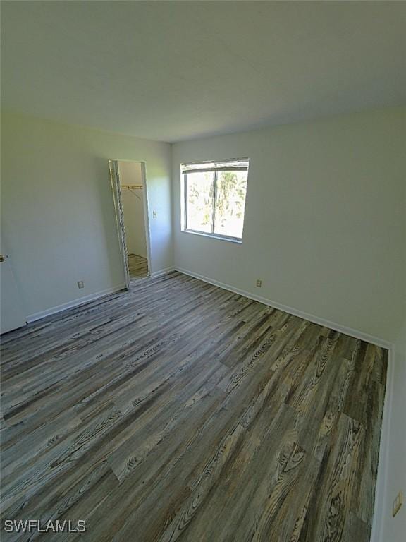 spare room with dark wood-type flooring