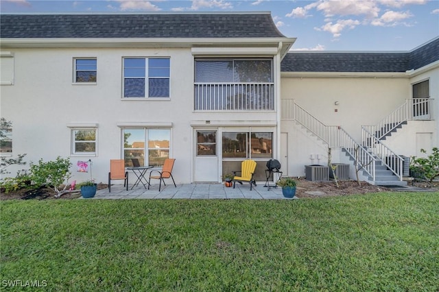 back of house featuring a patio area and a yard