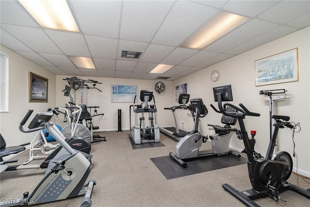 gym featuring a paneled ceiling and carpet flooring