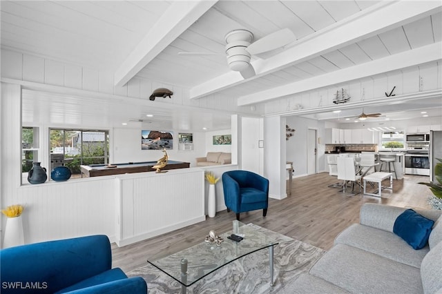 living room with beamed ceiling, light wood-type flooring, a healthy amount of sunlight, and billiards