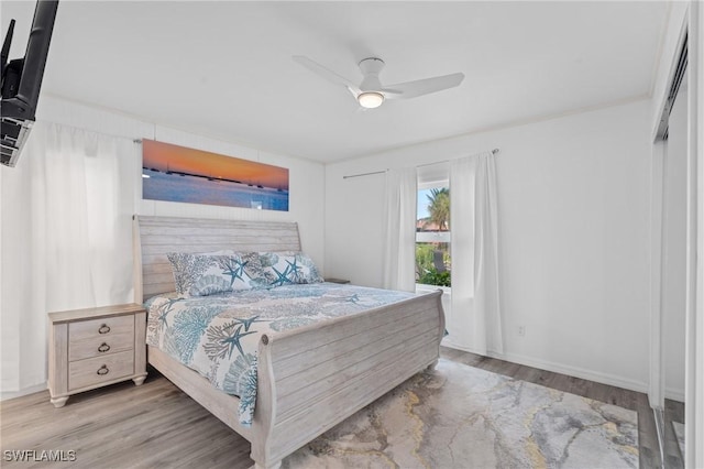 bedroom with light hardwood / wood-style floors and ceiling fan