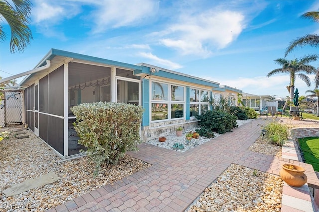 back of house featuring a sunroom