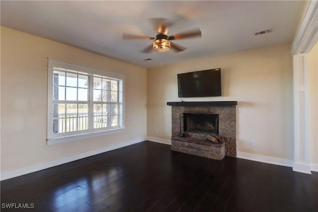 unfurnished living room with a fireplace, dark hardwood / wood-style floors, and ceiling fan