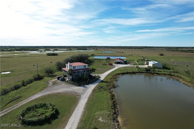 birds eye view of property with a rural view and a water view