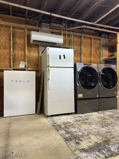 laundry room featuring washing machine and dryer and an AC wall unit