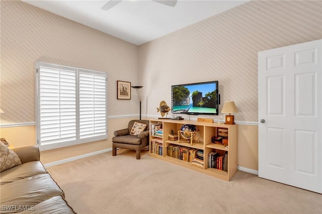 living room with ceiling fan and carpet