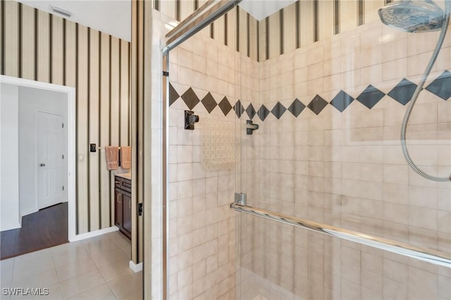 bathroom with tile patterned flooring and walk in shower