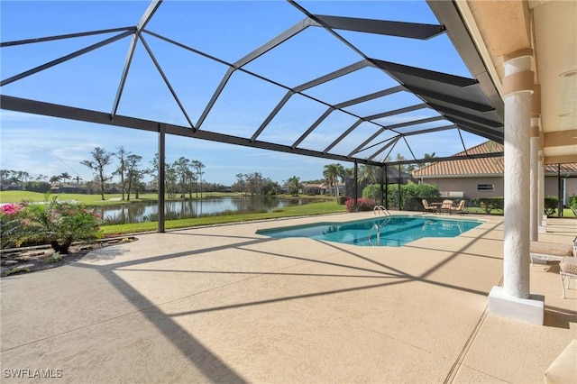 view of pool with a water view, glass enclosure, and a patio area