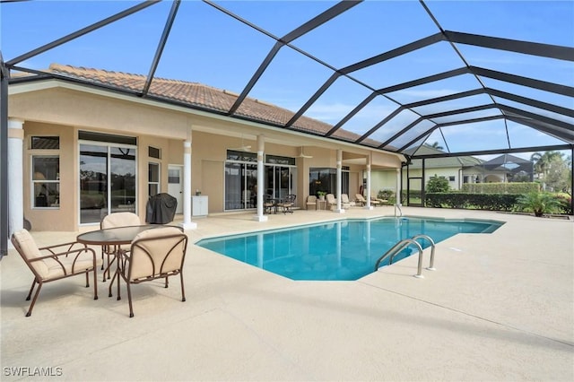 view of swimming pool featuring a lanai and a patio