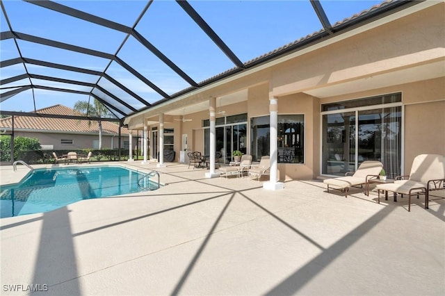 view of swimming pool featuring a patio area and a lanai