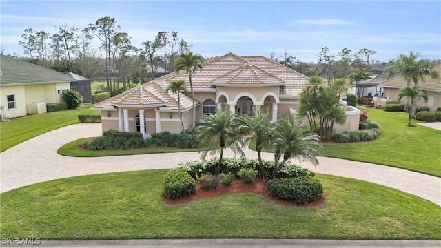 mediterranean / spanish house with a front lawn