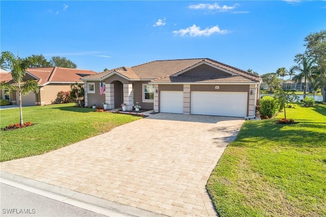 single story home featuring a garage and a front lawn