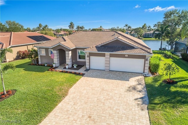 ranch-style house with a water view, a front yard, and a garage