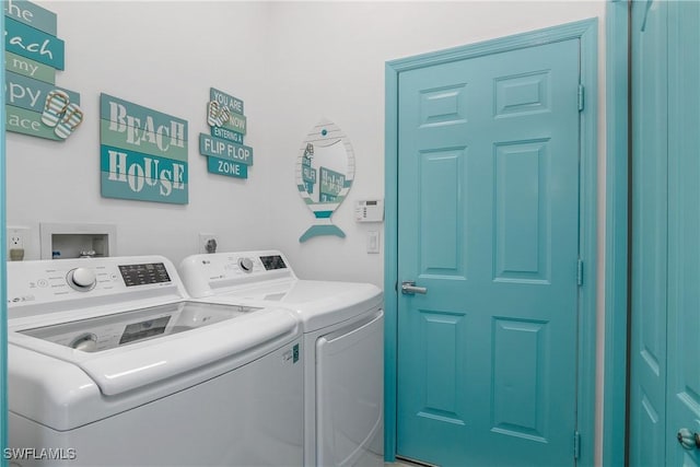 clothes washing area featuring independent washer and dryer