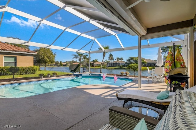 view of swimming pool with a lanai, a patio area, and a water view