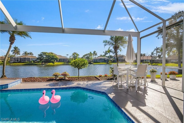 view of swimming pool featuring glass enclosure, a water view, and a patio