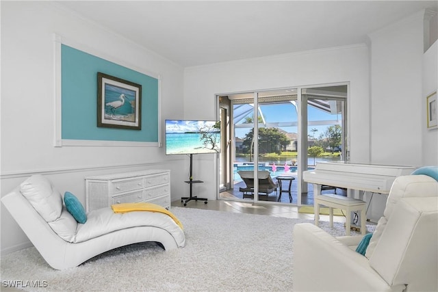 sitting room with tile patterned floors and crown molding