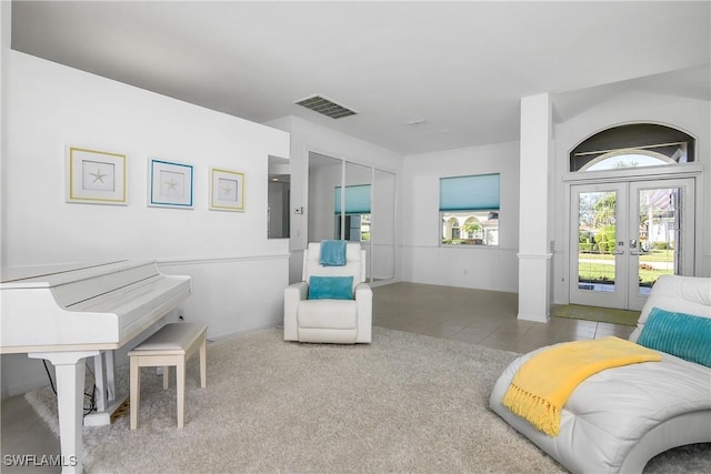 sitting room featuring french doors and light tile patterned floors