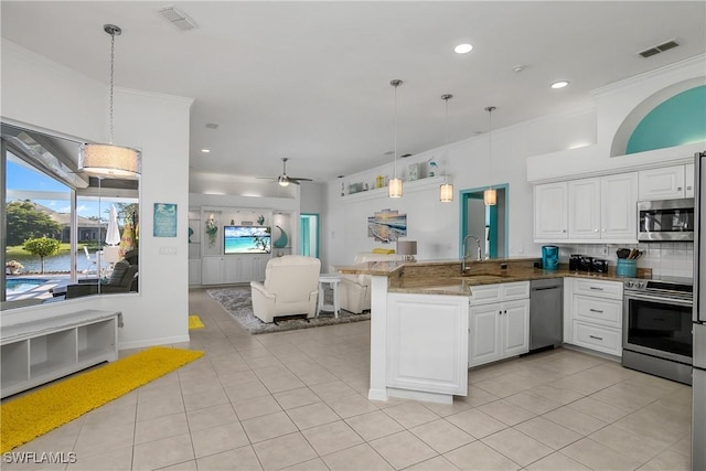 kitchen with kitchen peninsula, appliances with stainless steel finishes, white cabinetry, and ceiling fan