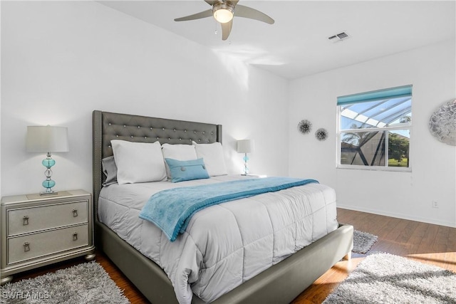 bedroom with ceiling fan and dark wood-type flooring