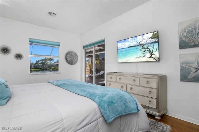 bedroom featuring dark hardwood / wood-style flooring and access to outside