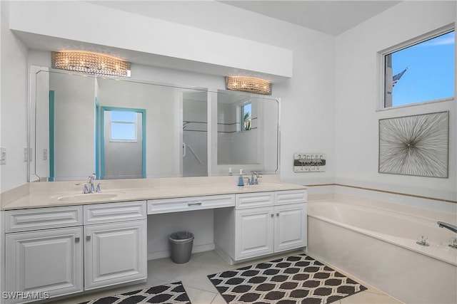 bathroom featuring tile patterned flooring, vanity, and a bathing tub