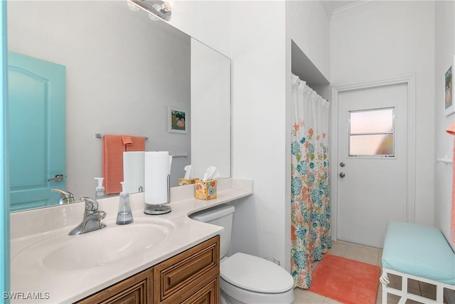 bathroom with toilet, vanity, and tile patterned floors