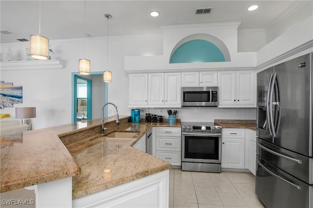 kitchen with decorative light fixtures, white cabinetry, and appliances with stainless steel finishes