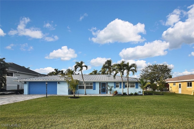 ranch-style home featuring a front lawn and a garage