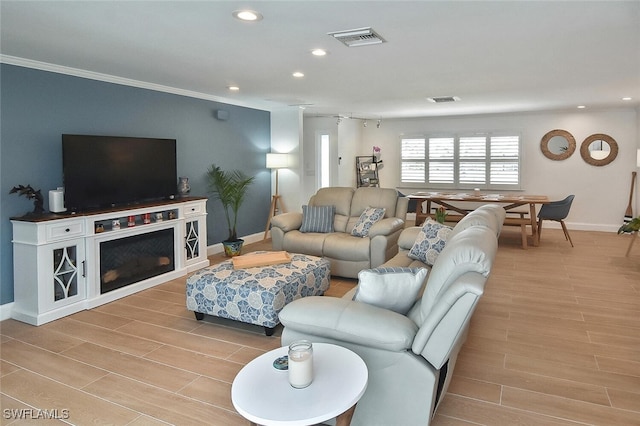 living room featuring light hardwood / wood-style floors and ornamental molding