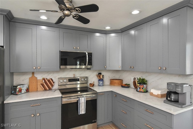 kitchen with appliances with stainless steel finishes and gray cabinets