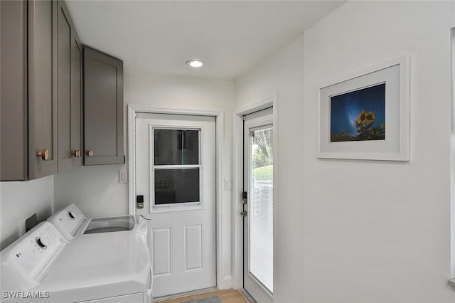 laundry area with cabinets and washer and clothes dryer