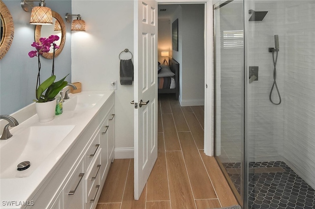 bathroom featuring vanity and an enclosed shower