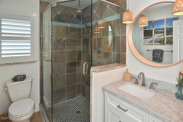 bathroom featuring walk in shower, tile patterned floors, vanity, and toilet