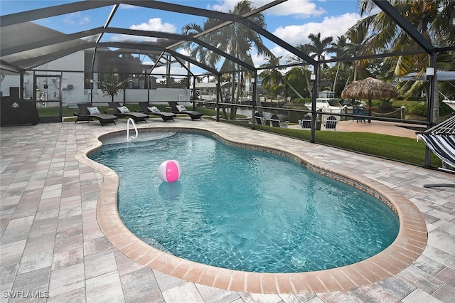 view of pool with a lanai and a patio