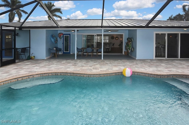 view of pool with a lanai, ceiling fan, and a patio area