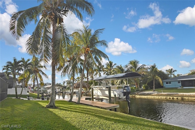 dock area with a yard and a water view