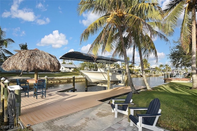 dock area featuring a lawn and a water view