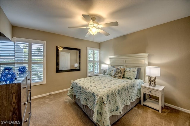bedroom featuring carpet flooring, ceiling fan, and multiple windows