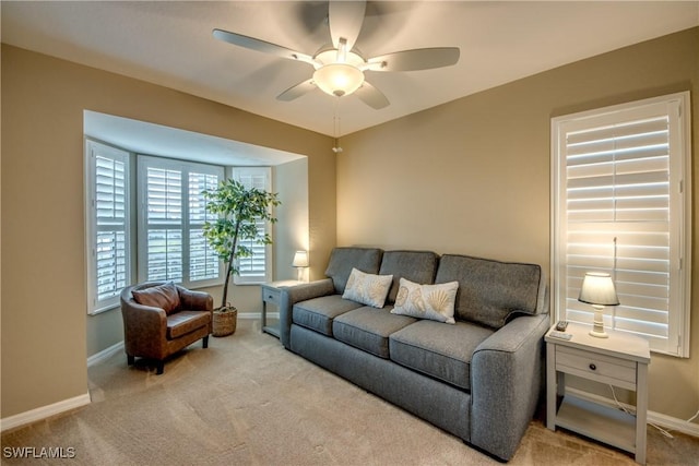 carpeted living room with ceiling fan