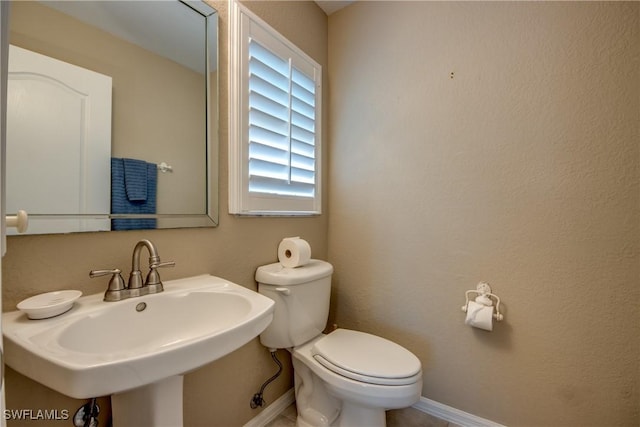 bathroom featuring sink and toilet