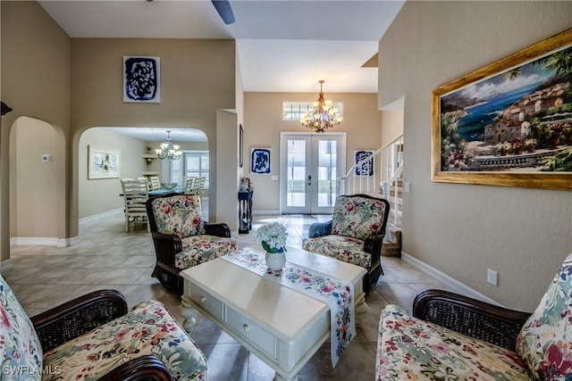 living room featuring a notable chandelier, light tile patterned flooring, and french doors