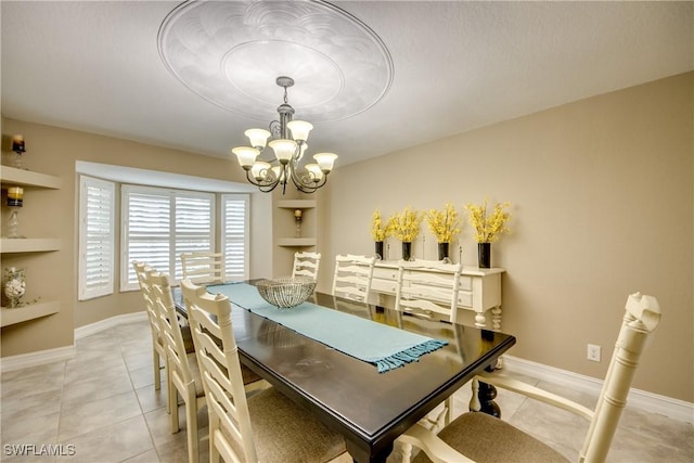 tiled dining area with built in shelves and a notable chandelier