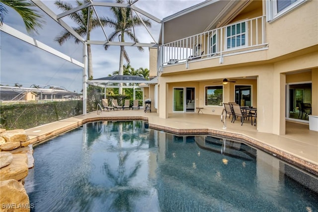view of swimming pool with a patio, glass enclosure, grilling area, and ceiling fan