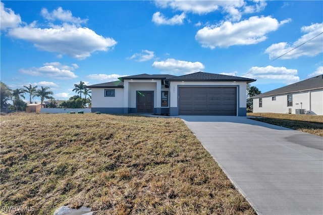 view of front of property featuring a garage and cooling unit