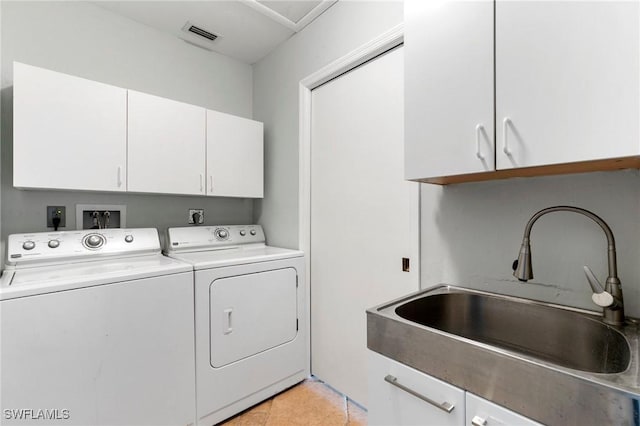 laundry room with sink, light tile patterned flooring, cabinets, and independent washer and dryer