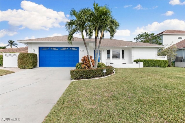 ranch-style home with a front lawn and a garage