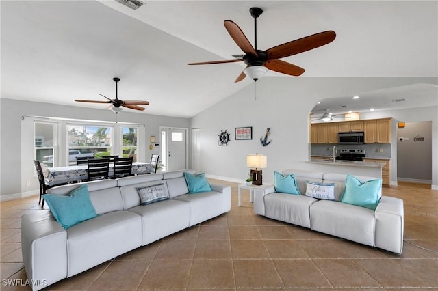 living room featuring vaulted ceiling and sink